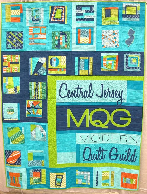 Central New Jersey MQG Banner by members of the Central jersey MQG. Phillipsburg, New Jersey. Pieced by Neva Asinari, Janet Bergman, Amy Blanchard, Helen Branch, Robin Buscemi, Christina Di Marco, Susan Flick, Andy Foster, Elaine Hagaman, Tatiana Kennedy, Jessica Levitt, Sandy Mahaney, Teddi Munslow, Lori Saporito, Linda Schulz, Rachel Singh, Jessica Skultety. Quilted by Jessica Levitt. 3rd place, Group or Bee Quilts, QuiltCon 2015.