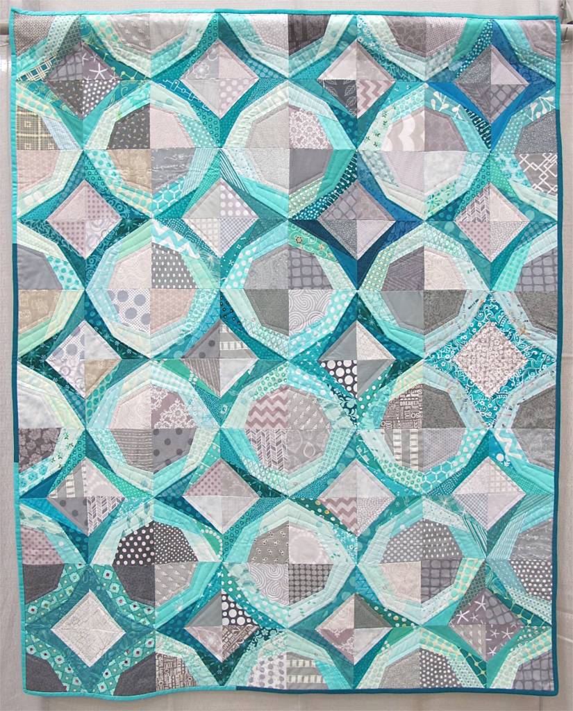 Icicles. Portland, Oregon. Pieced by Cath Hall, Ellen McKee, Suzy Lampman, Melanie Hughes, Nicole Boone, Kimberly Swink, Natalie, Weaver. Quilted by Cath Hall. Design Source: Paper piecing pattern Icky Thump by Julie Hirt of 627Handworks.