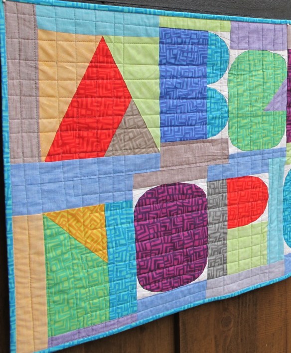 close-up of I Spy The Alphabet pattern by Terri Carpenter in a banner format sewn by Carol Van Zandt Version 2